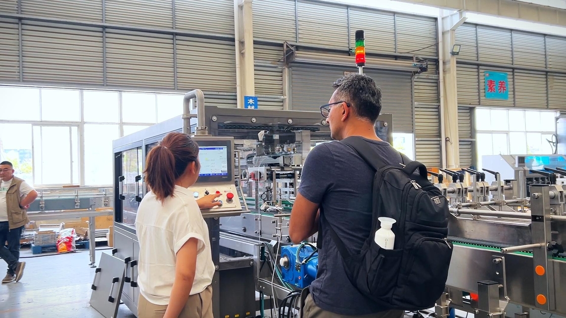 American Ice Cream Customers Watch The Video Of Case Packing Equipment Running On Site